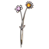 Early 20th century floral brooch with pink topaz and imperial topaz, featuring diamond petals.