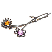 Austro-Hungarian gold brooch featuring pink and imperial topaz in a floral design with diamond accents.